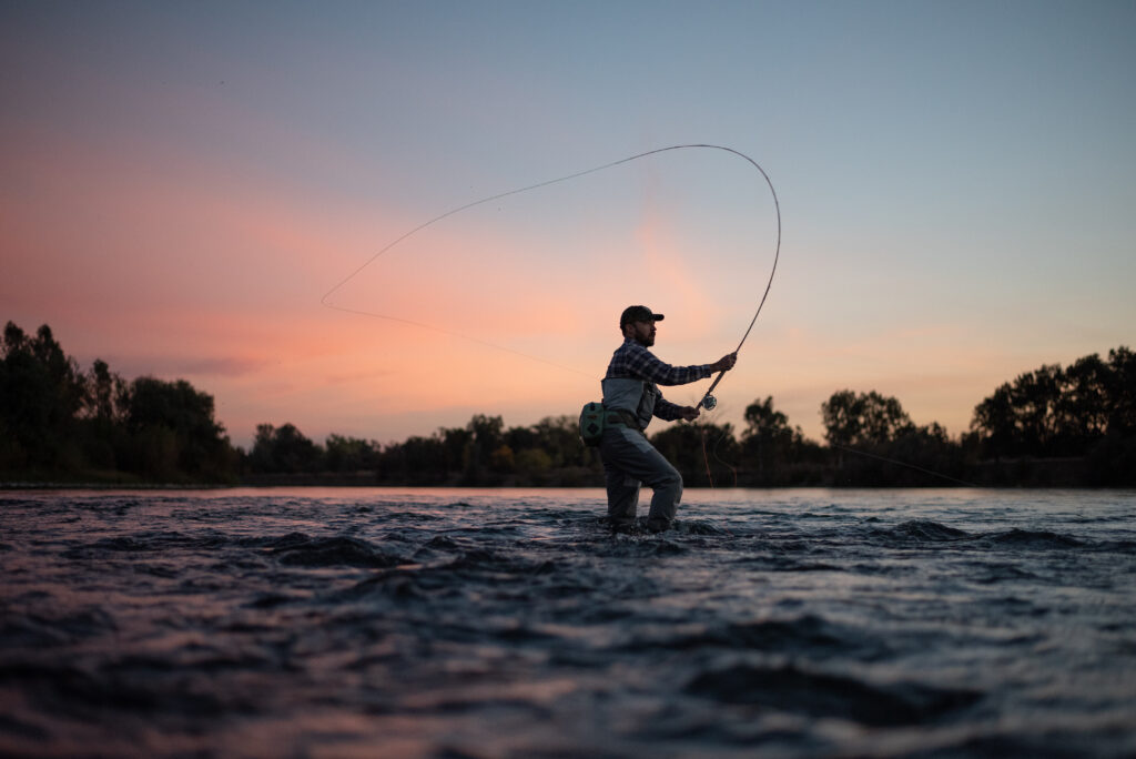Angler spey casting at sunset