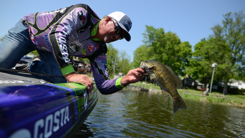 Jimmy Reese holding up a bass