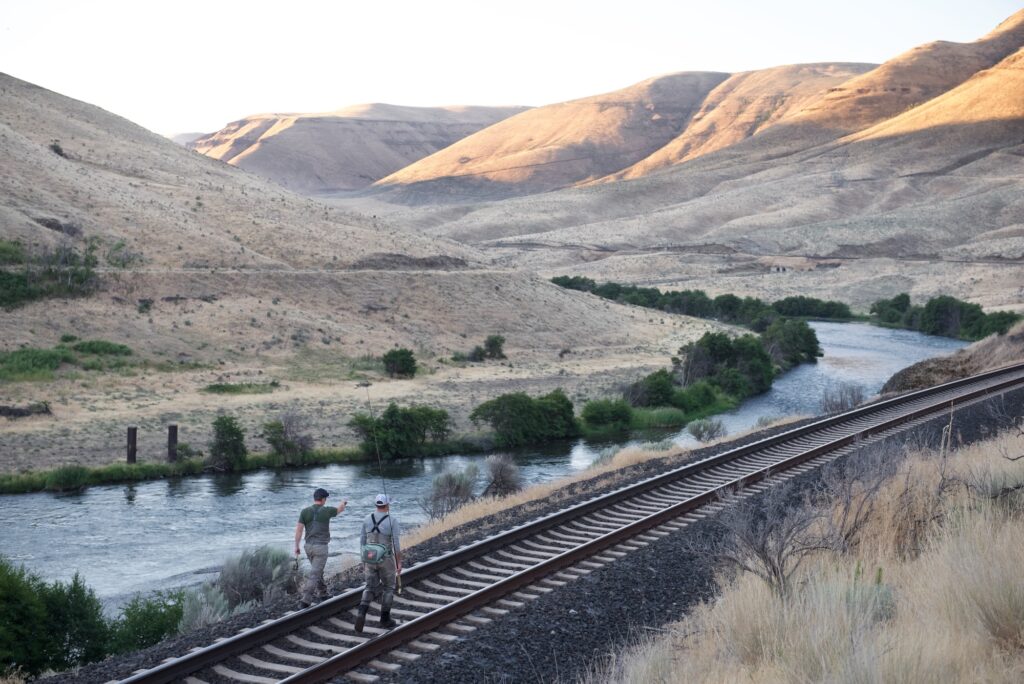 Anglers walking along the railroad tracks on the Deschutes River